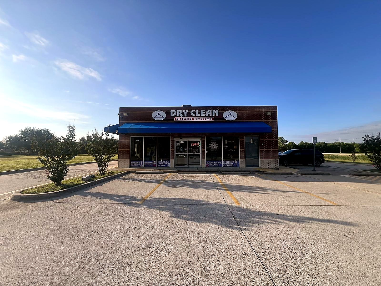 Dry Clean Super Center storefront and parking area in Burleson